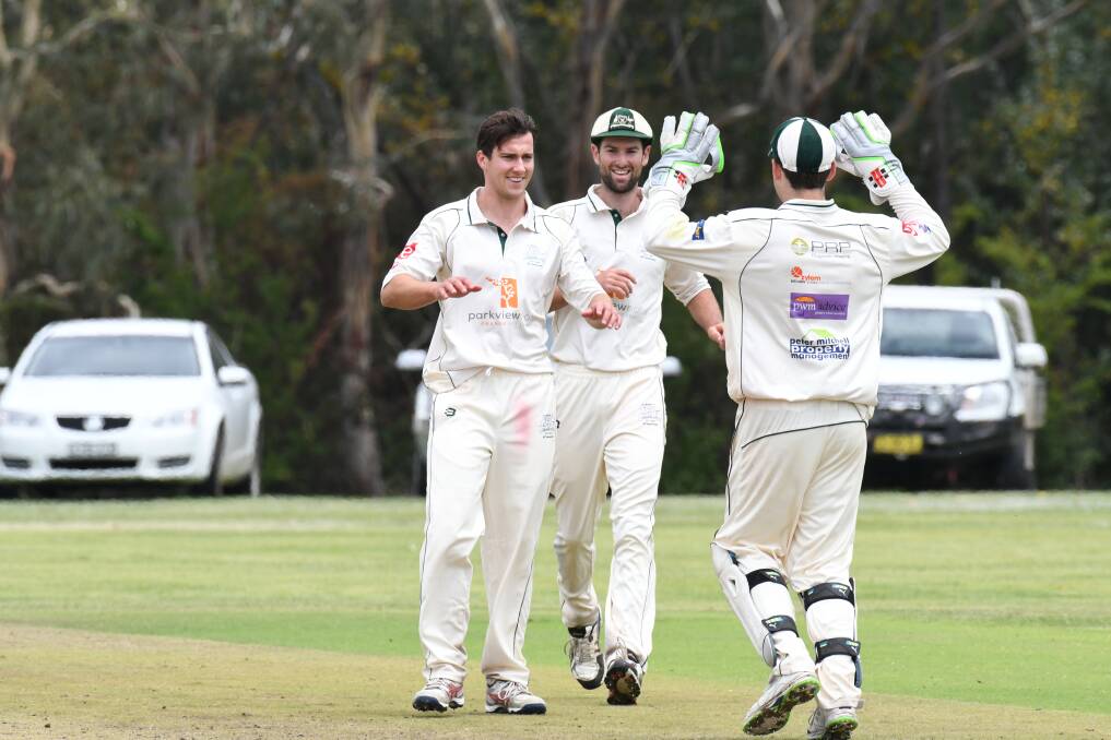 GOT HIM: Taylor Beatty celebrates taking his first wicket for City alongside Jackson Coote and Lachlan Coyte. Photo: JUDE KEOGH