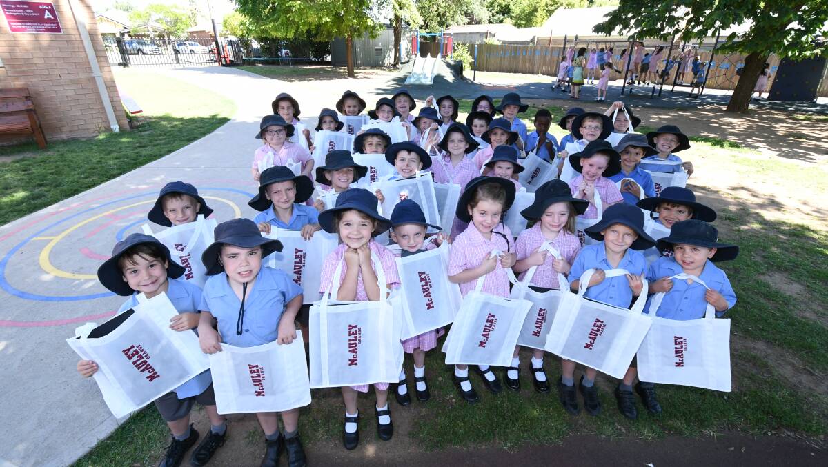 ENVIRONMENTAL THINKING: Some of Catherine McAuley Catholic School's youngest students with their new re-usable shopping bags. Photo: JUDE KEOGH 1213jkbags1