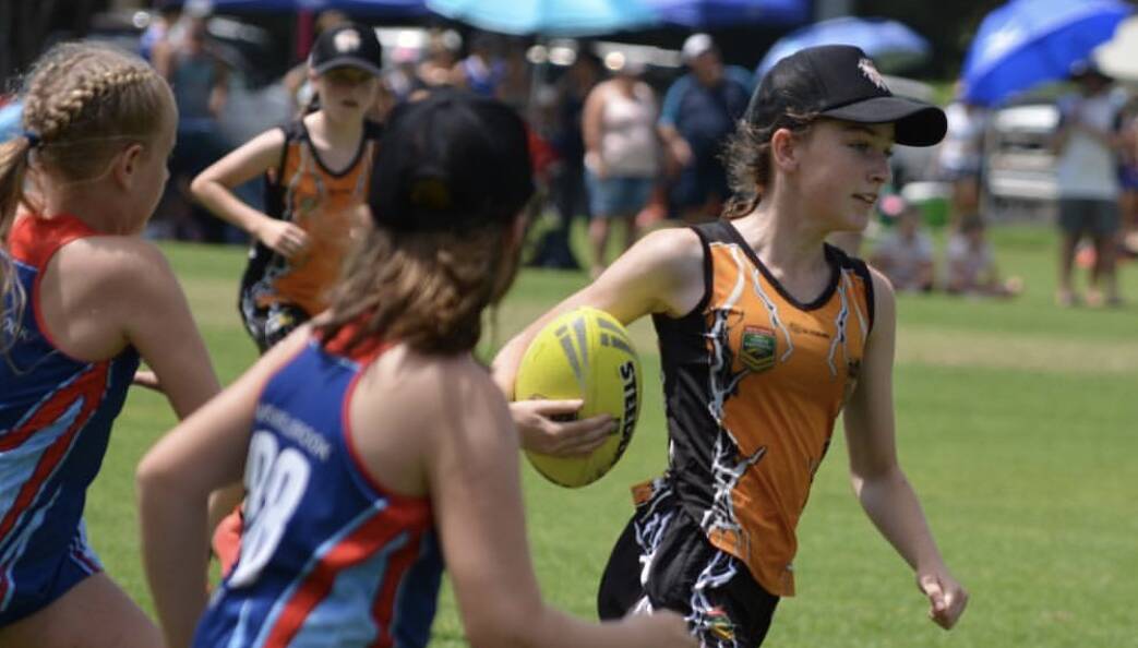 CATCH ME IF YOU CAN: Orange Thunder under 12s' Mya Simmons breaks away from the pack on their way to winning their division this weekend. Photo: SUPPLIED. 
