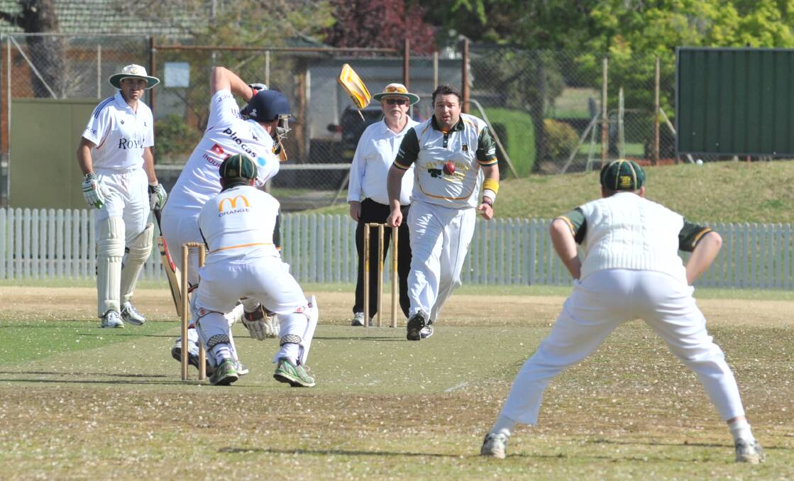 NOT THEIR DAY: As captain Daryl Kennewell (white hat) looks on, Centrals batsman Jake Pauletto snaps his bat in two driving the ball at Wade Park yesterday. Photo: JUDE KEOGH 1014jkwade9