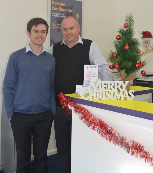 CHRISTMAS CHEER: Dylan and Barry Swain in their decked out office.
