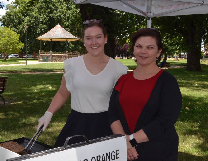 SUPPORT TEAM: Ashleigh Cooke and Rebecca Hawkins were manning the barbecue at Phil Donato's meet and greet on Thursday. Photo: MAX STAINKAMPH 1207MSphil2