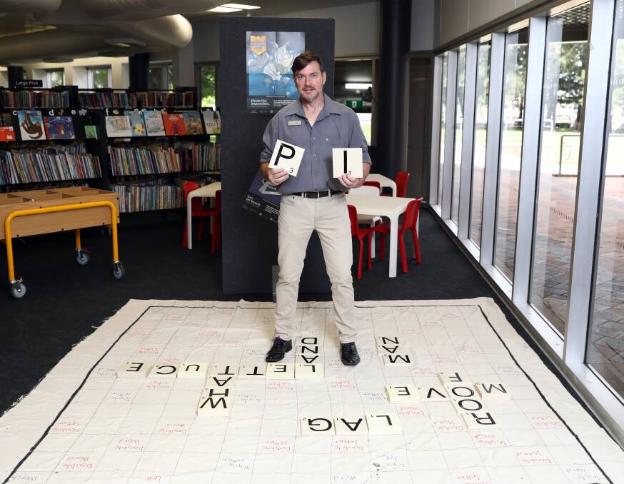 PERSON OF INTEREST: Orange City Librarian is calling people to the library's giant scrabble board for Summer Reading Club. Photo: ANDREW MURRAY 1201amlib1