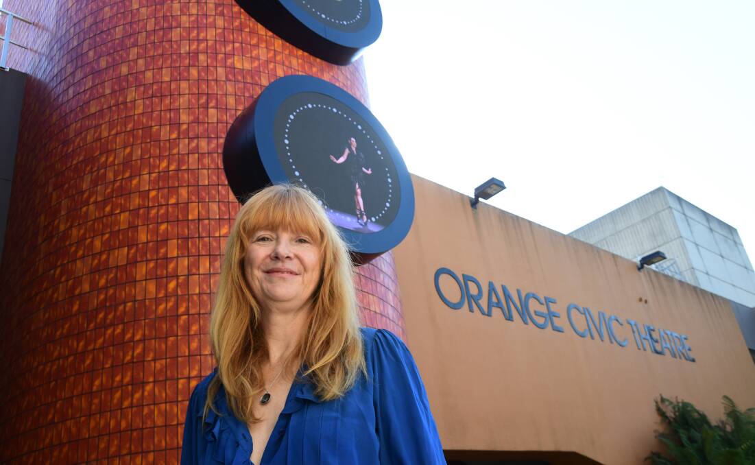 Zanny Begg in front of the dancing bee clocks outside the Orange Civic Centre. Picture by Carla Freedman
