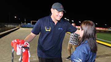 Jay Opetaia embraces Karen Ulrick after their dog Go Bears won the Richmond Derby on March 6. Picture by Lachlan Naidu
