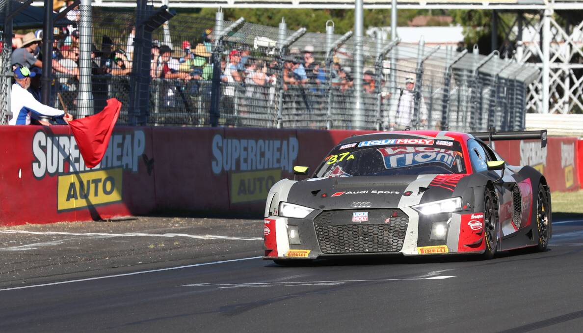 FINISHED EARLY: Robin Frijns drives his Audi across the line as the red flag is waved in Sunday's Bathurst 12 Hour. Photo: PHIL BLATCH