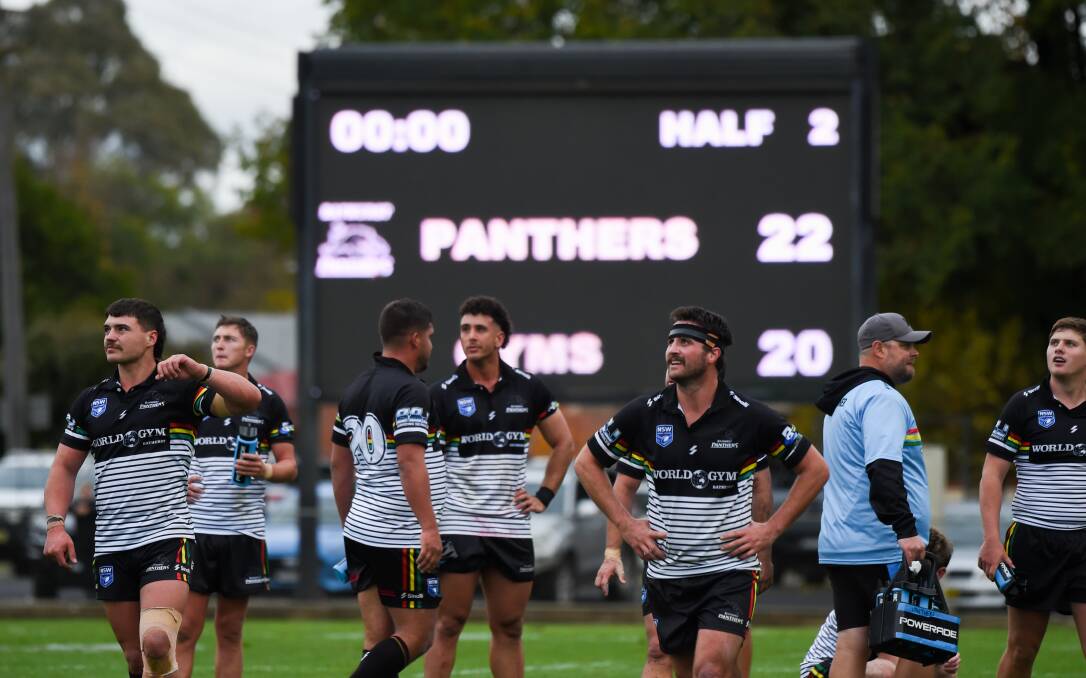 A happy Panthers player-coach Jake Betts (third from right) stands in front of the final scoreboard. Picture by James Arrow.