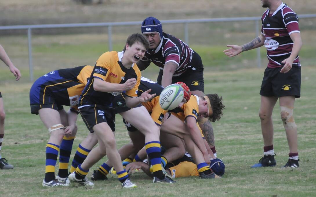 GOOD FIGHT: CSU's Ben Reading-Thompson sends the ball away from the ruck in his side's defeat to the Parkes Boars on Saturday. Hosts CSU fought back but went down 33-22. Photo: CHRIS SEABROOK