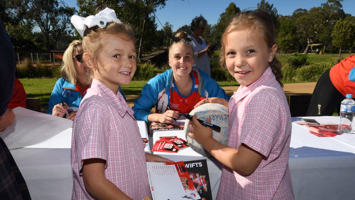 ALL SMILES: Dubbo's Maya Hyde and Mia Richardson pose for a photo with NSW Swift Maddy Turner after getting an autograph. Photos: BELINDA SOOLE