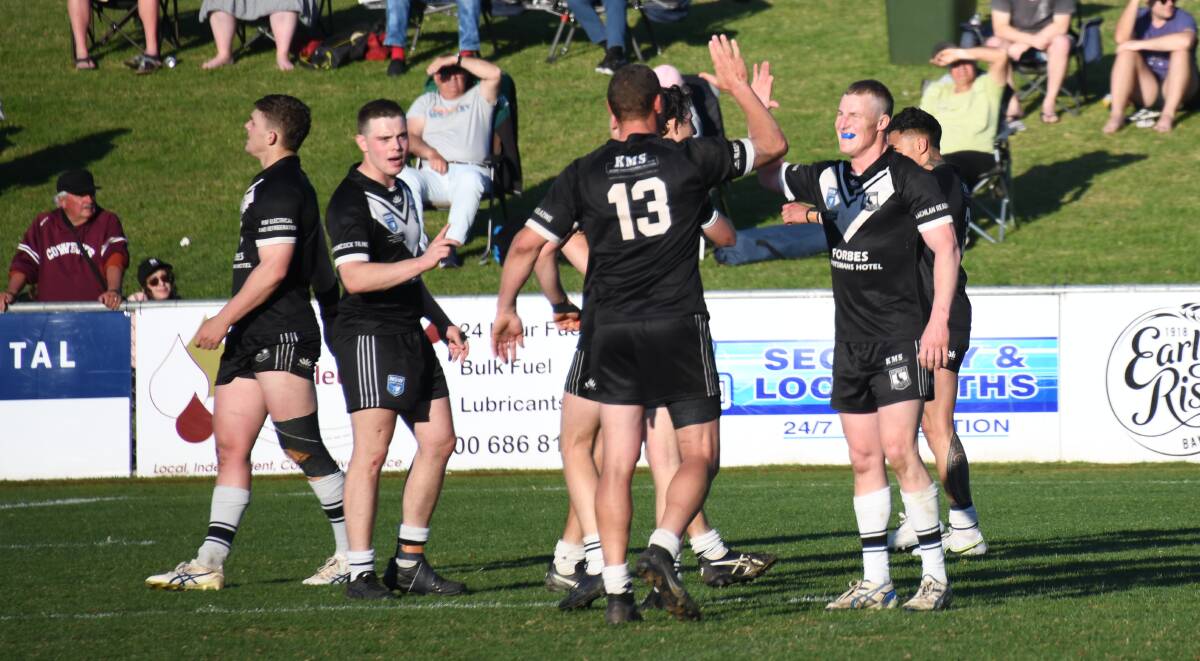 Jake Haddrill (right) celebrates with teammates after Forbes won the 2022 Peter McDonald Premiership grand final. Picture by Amy McIntyre