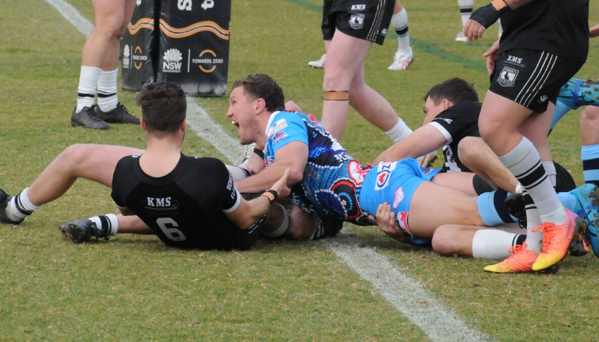 Jarrod Michael roars with delight after scoring Macquarie's first try on Sunday. Picture by Nick Guthrie