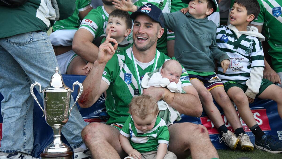 Grand final man of the match Jarryn Powyer with the premiership silverware and his sons Sonny and Rowdie (front). Picture by Amy McIntyre