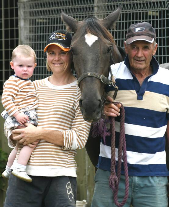 FAMILY AFFAIR: Jane Morris, her daughter Poppy, horse Scarlett, and father Kel Winnell finish up the day's work at their stables in Spring Hill. Photo: JUDE KEOGH