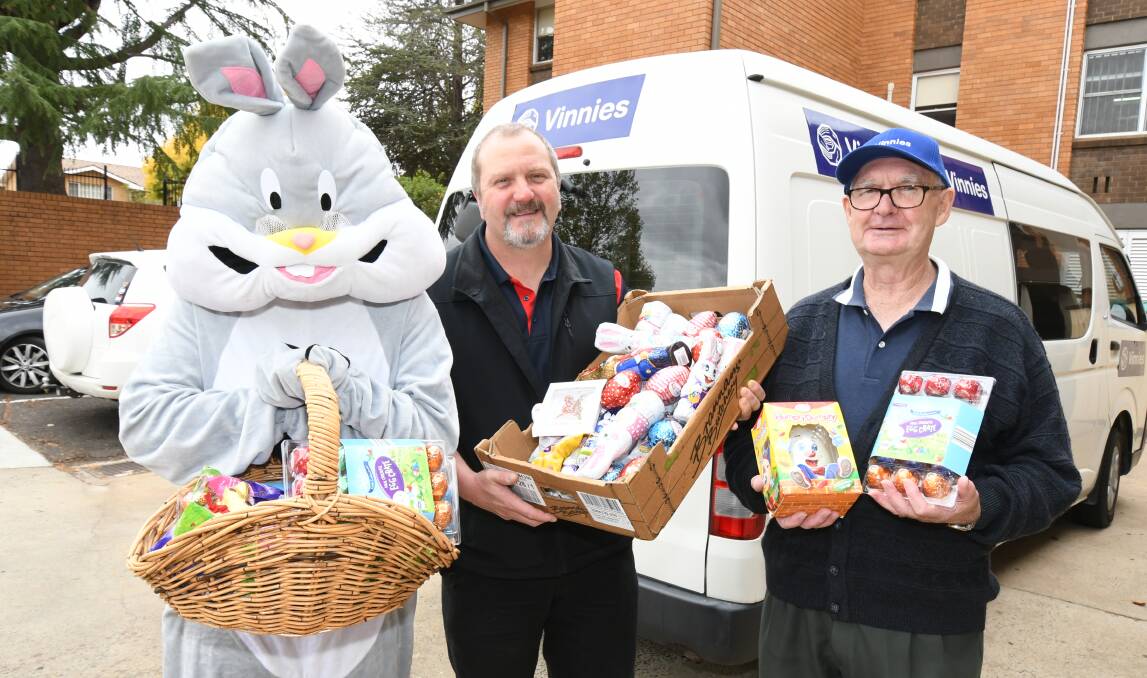 SWEET HOLIDAY: Easter bunny aka Chloe Holmes, Bill Rollo and Barry Frecklington making Easter a little sweeter. Photo: JUDE KEOGH 0323jkeaster4