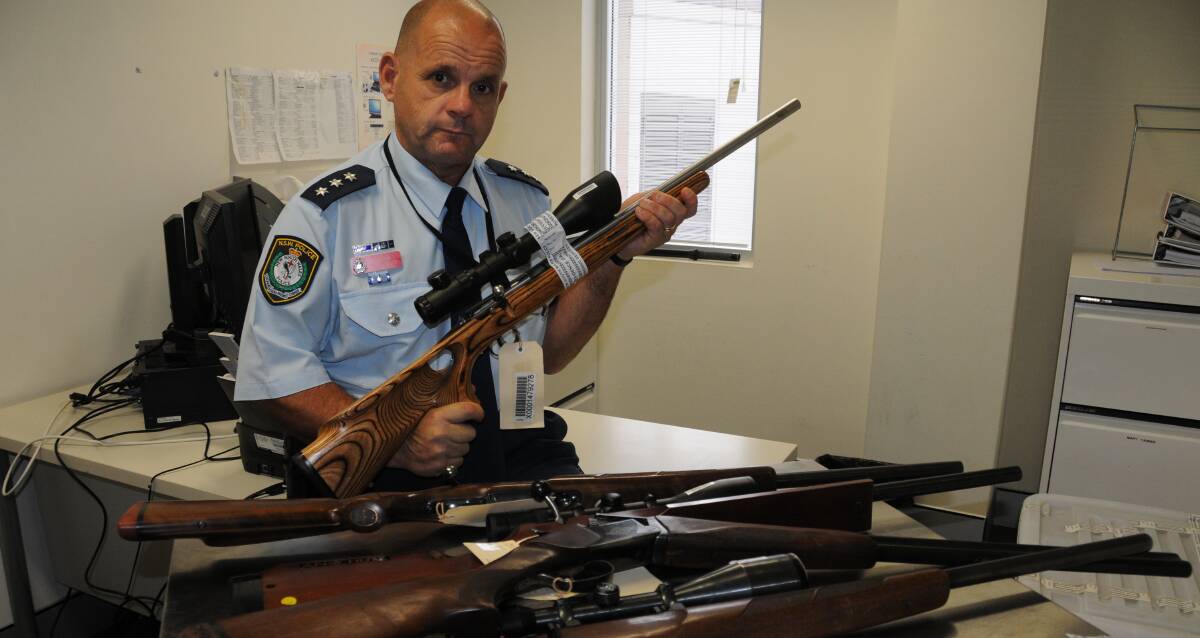 Vigilance: Inspector Dan Skelly from Orana Local Area Command with some of the firearms that have been stolen from rural properties. Photo: BEN WALKER 
