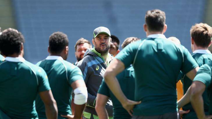 Coach Michael Cheika speaks to his players during the captain's run at Eden Park on Friday. Photo: Phil Walter