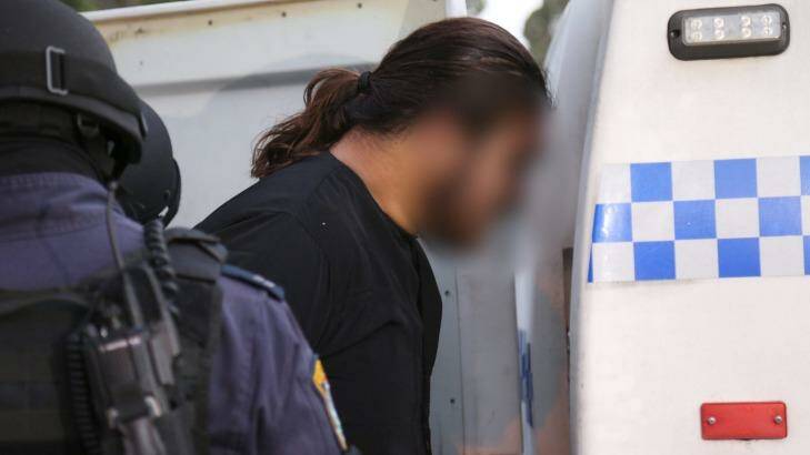 Police arrest a man after terrorism raids in Wentworthville on Wednesday in connection with the killing of police accountant Curtis Cheng. Photo: NSW Police