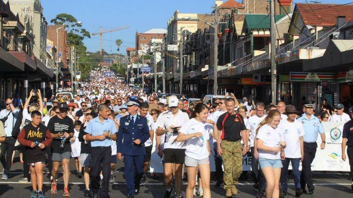 Thousands make their way down Coogee Bay Road as part of a walk in support of White Ribbon Day. Photo: Peter Rae