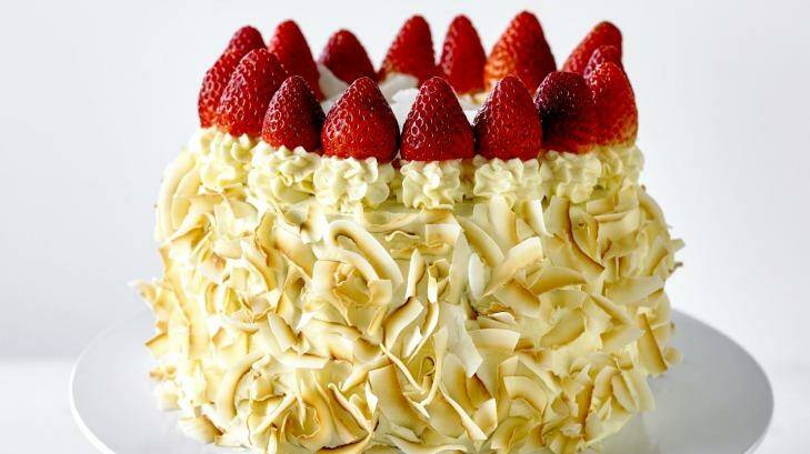 Julie's Coconut Cake is spread with apricot jam and buttercream and sprinkled with toasted coconut. Photo: Supplied