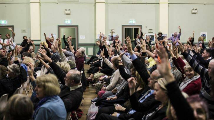 Attendants at a Stop WestConnex meeting at the Balmain Town Hall demonstrate the local opposition to the project.  Photo: Dominic Lorrimer