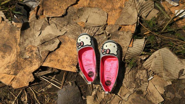 A pair of hello kitty shoes lay at one of the sites where the front section of Malaysian flight MH17 crashed and the pilots bodies were found. 298 people were killed, including 38 Australians. Photo: Kate Geraghty