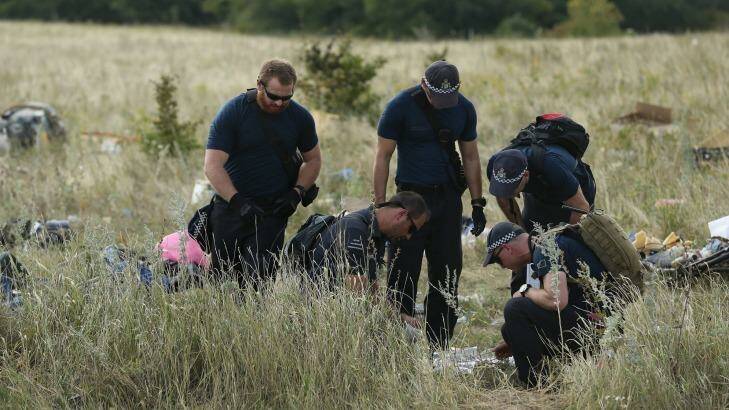 Australian Federal Police officers and their Dutch coutnerparts collect human remains from the MH17 crash site in the fields outside the village of Grabovka in the self-proclaimed Donetsk Republic, Ukraine on August 2, 2014.  Photo: Kate Geraghty