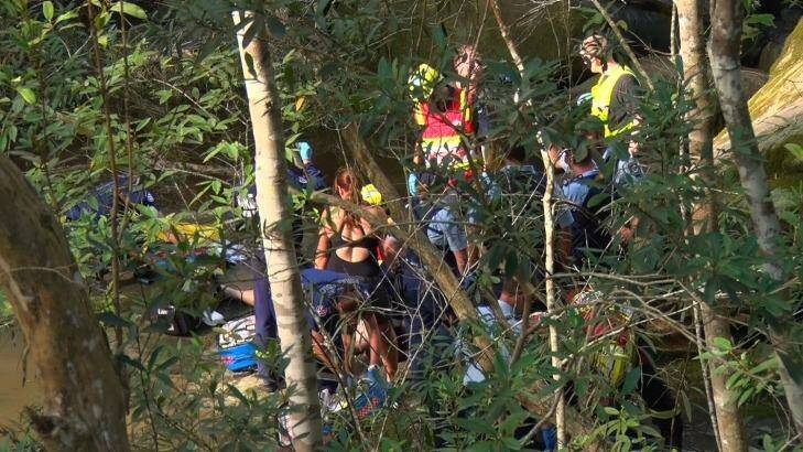 Emergency service workers try to save the life of a man who fell at Somersby Falls. Photo: Top Notch Video