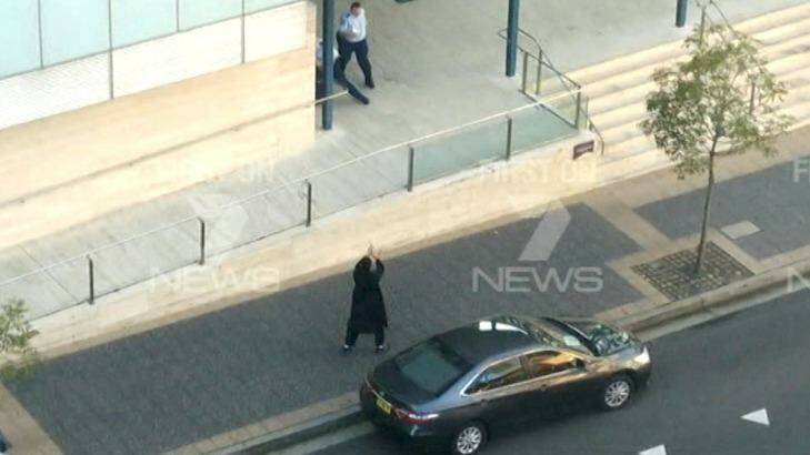 Chilling: Farhad Khalil Mohammad Jabar points his gun at a police officer. Photo: Channel Seven