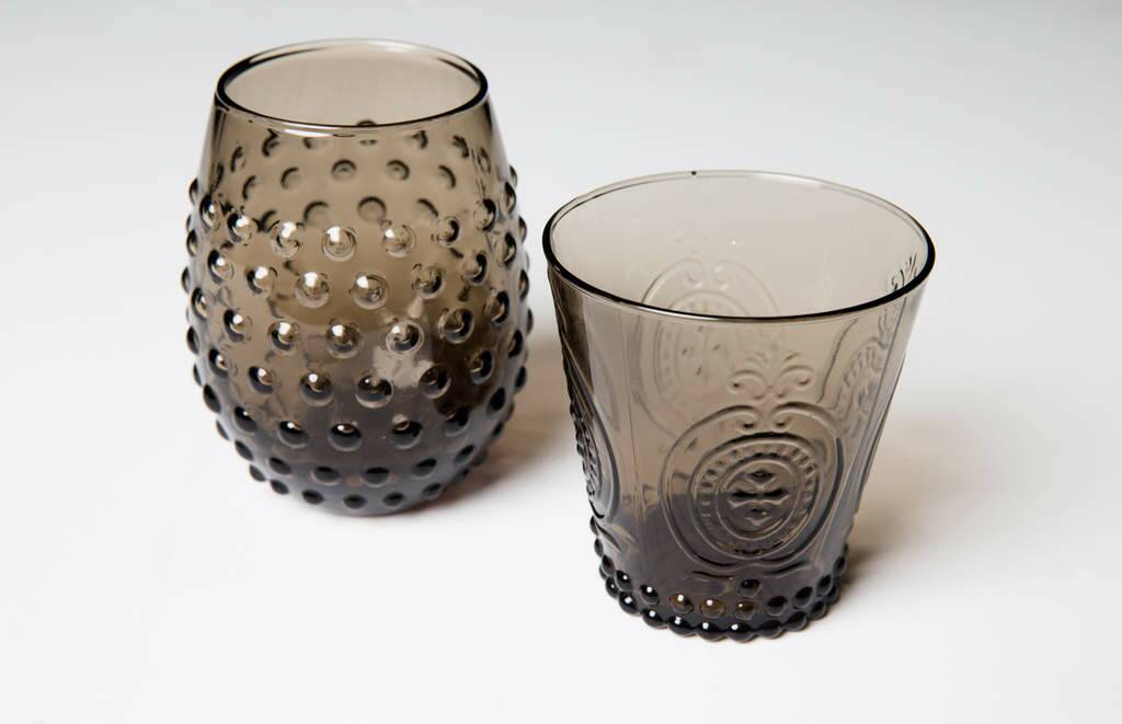 Contrast smoke-hued water tumblers with transparent wine glasses to add drama to the tablescape. From $5, freedom.com.au. Photo: Supplied