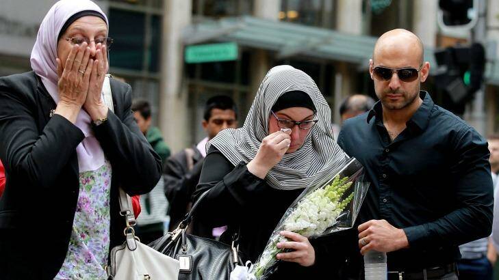Members of the Muslim community lay flowers at Martin Place after two people and a gunman died when the siege ended Tuesday morning.  Photo: Ben Rushton