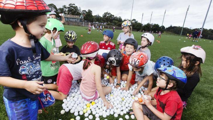 Northbridge Public School pupils at Northbridge Oval with some of the balls that have landed there. Photo: James Brickwood