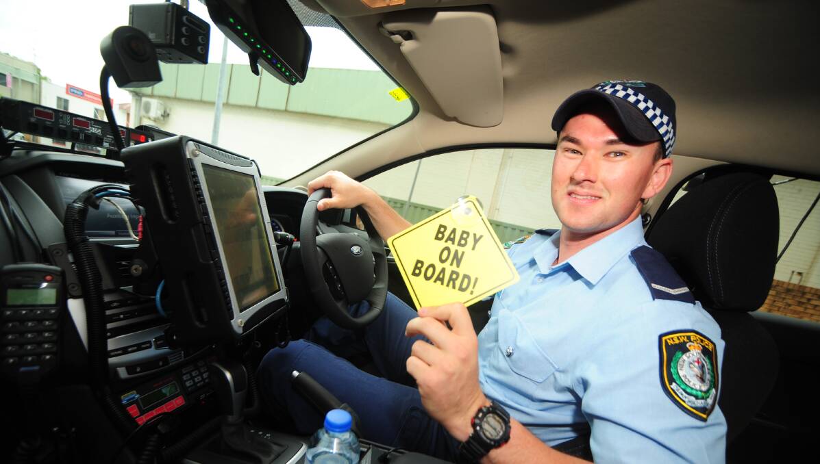 I'LL LET THIS ONE SLIDE: Constable Nick Richardson acted as a temporary ambulance when took a woman in labour to Dubbo Base Hospital yesterday. Photo: BELINDA SOOLE