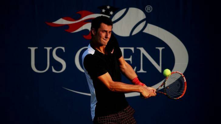 Safely through: Bernard Tomic returns a shot to Damir Dzumhur on Day Two of the 2015 US Open. Photo: Streeter Lecka