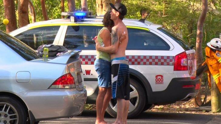 Nick Weston, who held the man after he fell from the top of Somersby Falls, comforts the man's mother. Photo: Top Notch Video