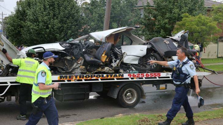 The wreckage of the car is towed away. Photo: Kirk Gilmour