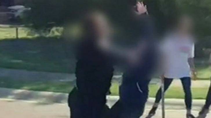A child can be seen carrying a bat as others fight. Photo: Channel Nine