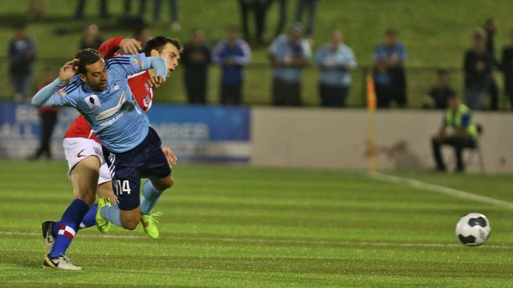 Tense affair: Sydney FC striker Alex Brosque is fouled by a Sydney United player. Photo: Brendan Esposito
