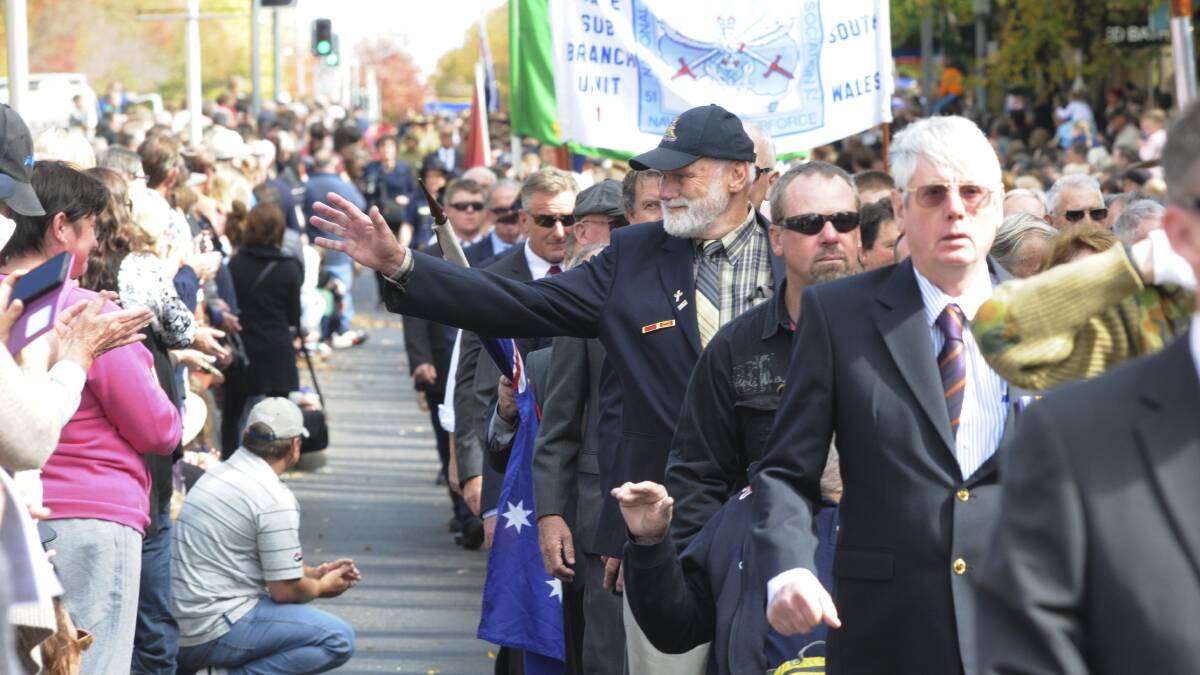 PROUD MOMENT: David Pepper-Edwards waves to the cheering crowd during the Anzac Day march down Summer Street on Saturday. Photo: JUDE KEOGH			           0425anzac15