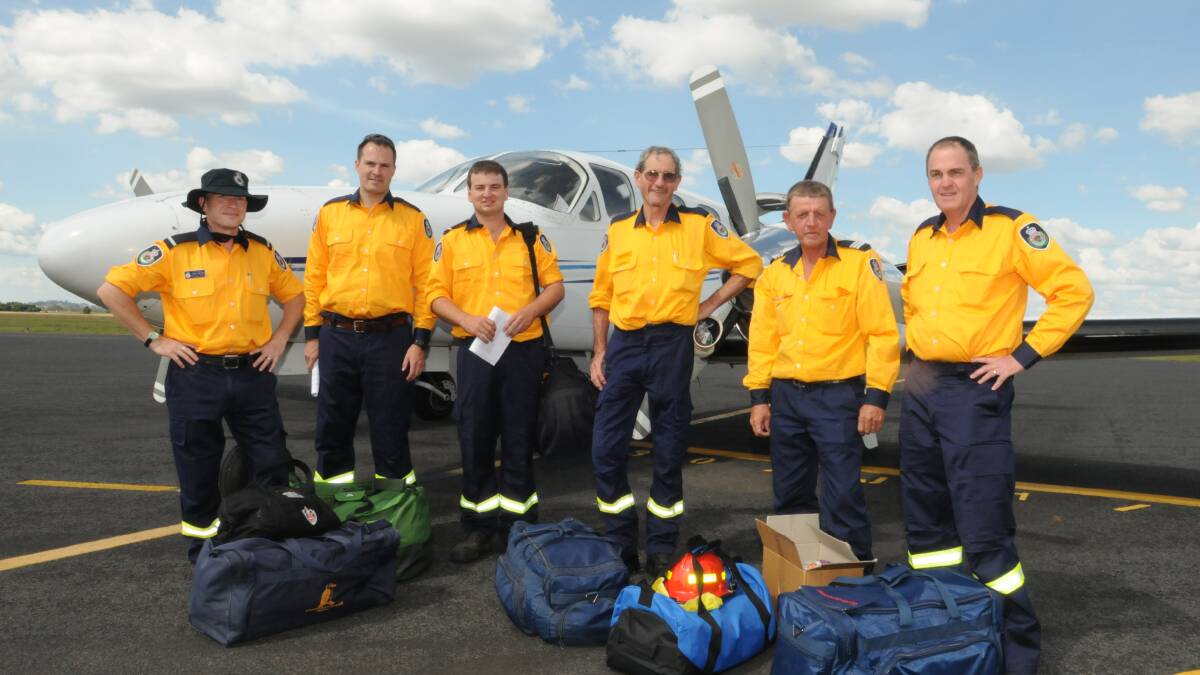 READY TO FLY: RFS firefighters Craig Petersen, Matt Staniforth, Mark Gray, Glen Griffith, Rodney Oxley and Ian Wotton prepare to go to South Australia to help with the firefighting effort. Photo: JUDE KEOGH. 	           0106rfs3