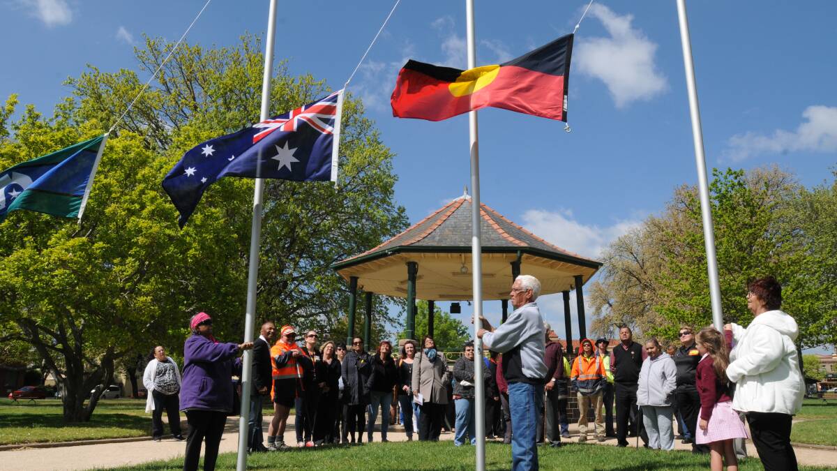 FLY THE FLAG: Topsy Nicholls, Pat French, Caitlyn Shields and Mary Parker raise the Torres Strait Islands, Australian and Aboriginal flags at the NAIDOC Week flag raising ceremony in Cook Park yesterday. Photo: STEVE GOSCH 1018sgflag1
