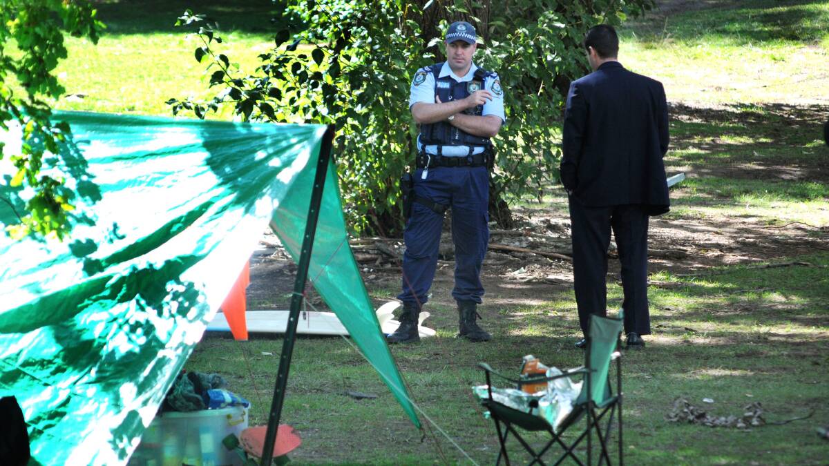 UNHAPPY CAMPERS: Police and council staff inspect the temporary camping ground at Lake Canobolas yesterday after campsites were shot at by passersby on Sunday. Photo: STEVE GOSCH  0331sglake1