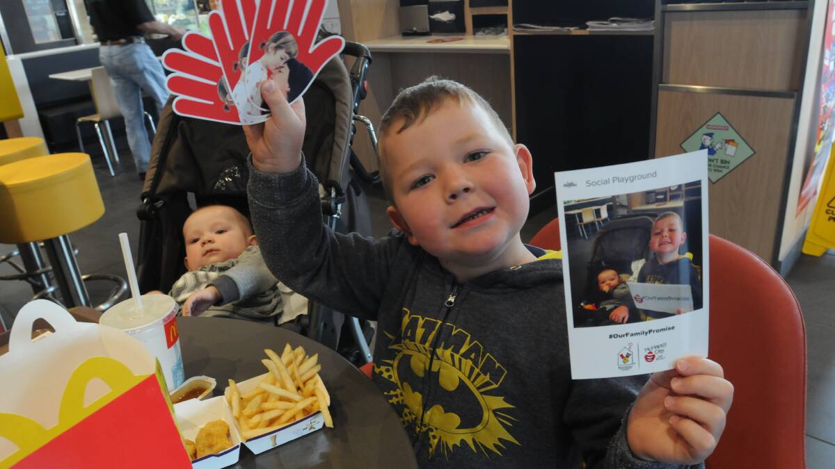 SHOWING SUPPORT: Angus Munday, six months, and Oscar Munday, 4, took part in an Instagram activity at Orange North McDonald’s on Monday in support of McHappy Day and Ronald McDonald House. Photo: STEVE GOSCH  1013sgmaccas2