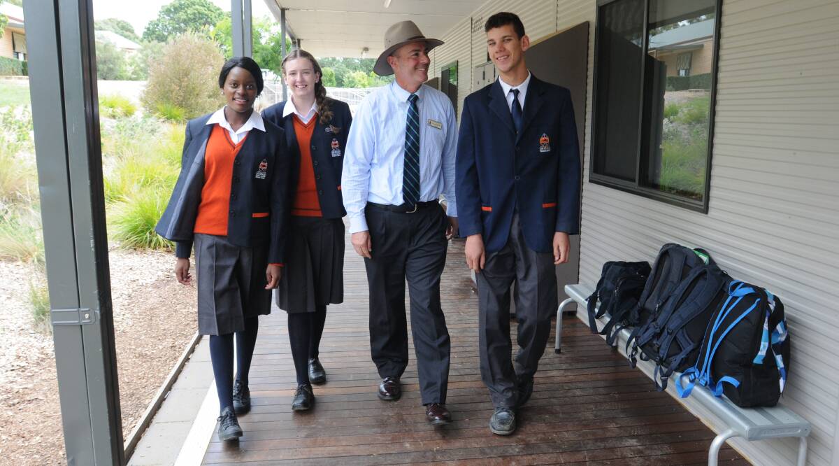ALL GROWN UP: Orange Anglican Grammar School welcomed its first cohort of Year 12 students yesterday. Principal Len Elliott is pictured with students Ashley Dube, Tessa Barrett and Peter Driver. Photo: JUDE KEOGH 0128year12anglican1
