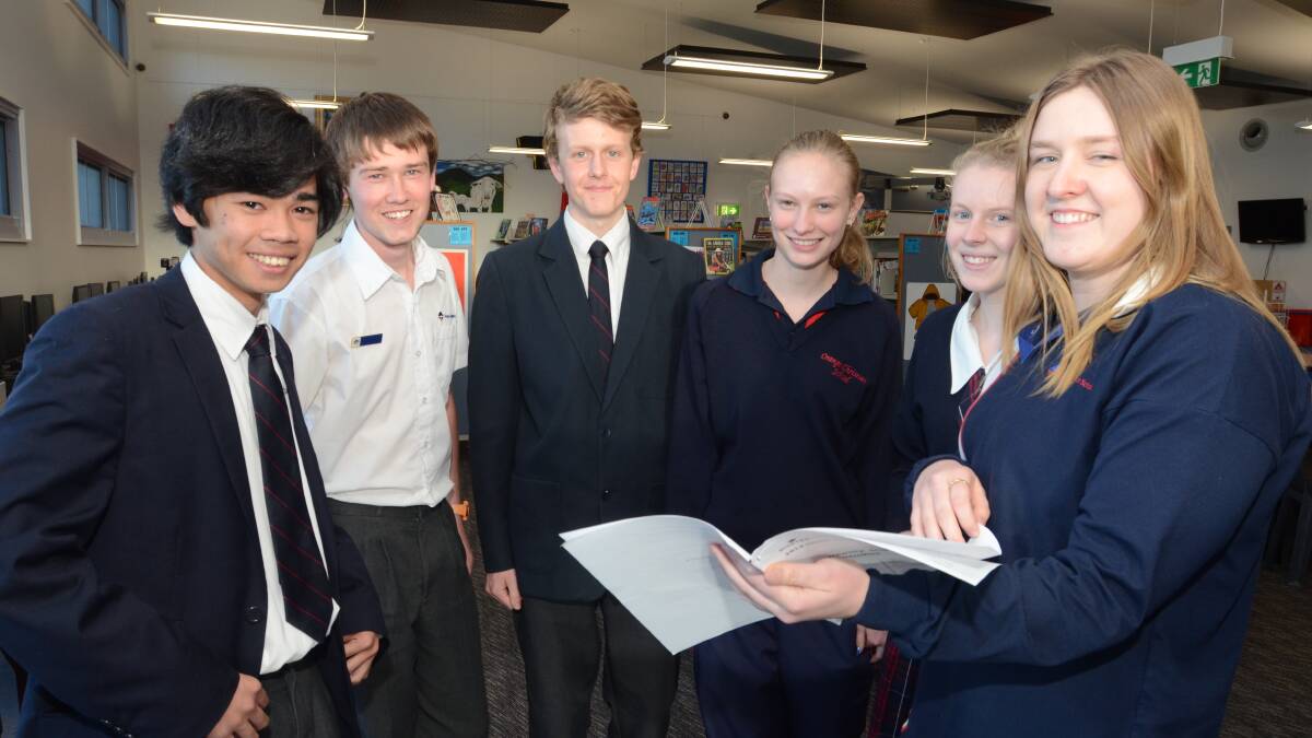 TOUGH QUESTIONS: (wide) Orange Christian School year 12 students Anthony Yonzon, Timothy Anikin, Zachary Pearson, Elizabeth Wittig, Nicole Filmer and Annalise Barnes swap answers after the Family and Communities HSC exam on Friday afternoon.  Photo: JUDE KEOGH 1017hsc1
