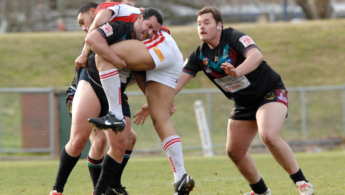 UPENDED: Bathurst Panthers' Trent Rose stops Mudgee's Demetrius Ainuu in his tracks. Photo: ZENIO LAPKA 070614zpan23