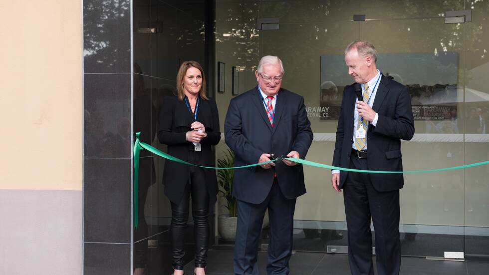 OPEN FOR BUSINESS: Orange mayor John Davis cuts the ribbon as Macquarie Infrastructure and Real Assets executive director Liz O’Leary and Paraway Pastoral Company chairman Bruce Terry look on. Photo: CONTRIBUTED