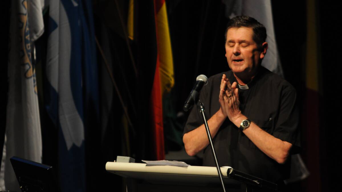 REACHING OUT: Youth Off The Streets founder Father Chris Riley speaks at Saturday’s Rotary district conference outlining his 40 years working with troubled young people. Photo: STEVE GOSCH 0322sgrotary4
