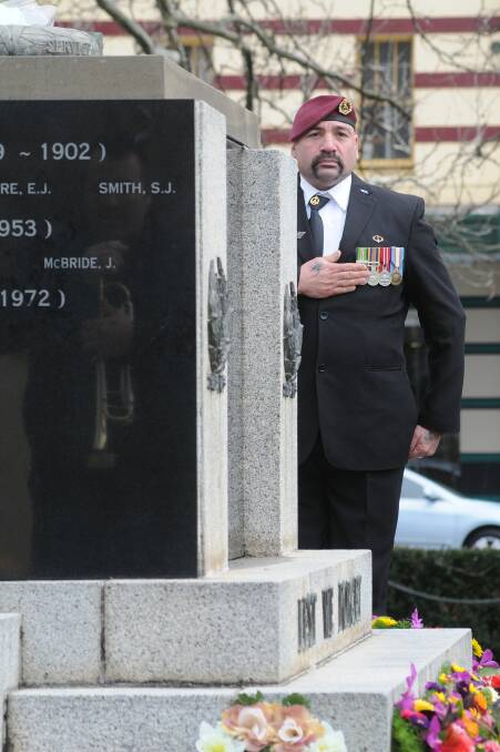 SACRIFICE: Orange RSL sub branch committee member and parade marshall Kevin Lenaghan pays his respects during a moving Vietnam Veterans’ Day ceremony yesterday. Photo: STEVE GOSCH 0818sgviet1