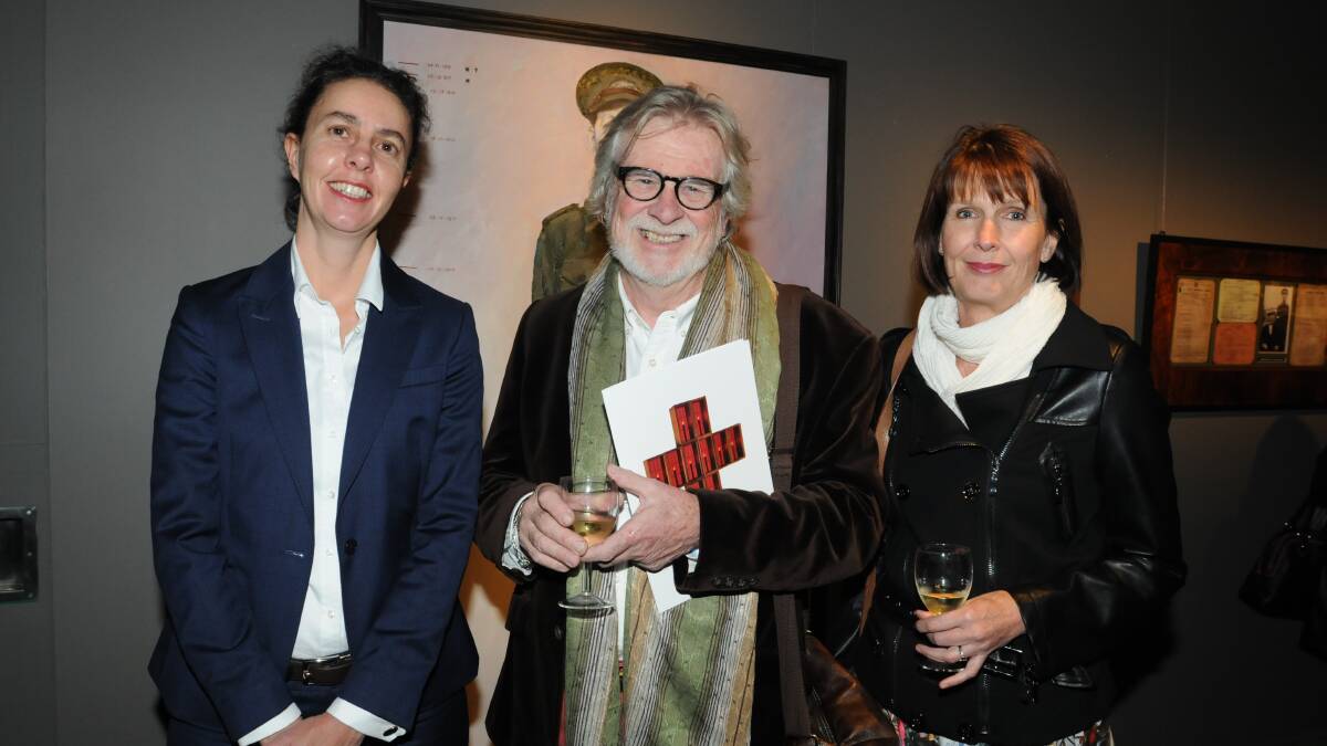 ANZAC EXHIBITION: Michael Caulfield (centre) who opened the memorate.com.au intallation on Friday night with Orange Regional Gallery director Lisa Loader (left) and Liz Butler. Photo: JUDE KEOGH 0424art6