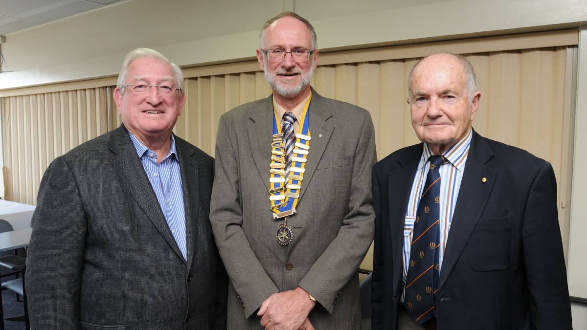 PRESTIGIOUS AWARD: Outgoing president of the Rotary Club of Orange Daybreak, John Willing (centre) congratulates Orange mayor John Davis and Dr Stuart Porges after they were honoured with Paul Harris Fellowships on Saturday night. Photos: STEVE GOSCH 0622sgdaybreaknews
